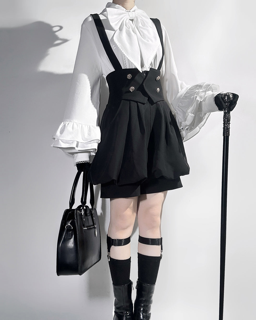 Stylish Black High-Waisted Suspender Shorts with Flared Skirt Overlay