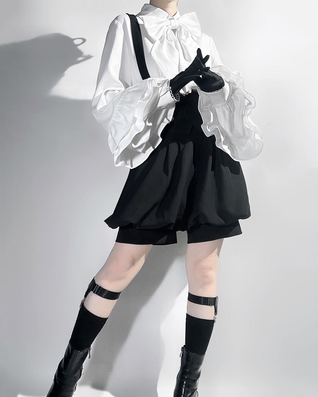 Stylish Black High-Waisted Suspender Shorts with Flared Skirt Overlay