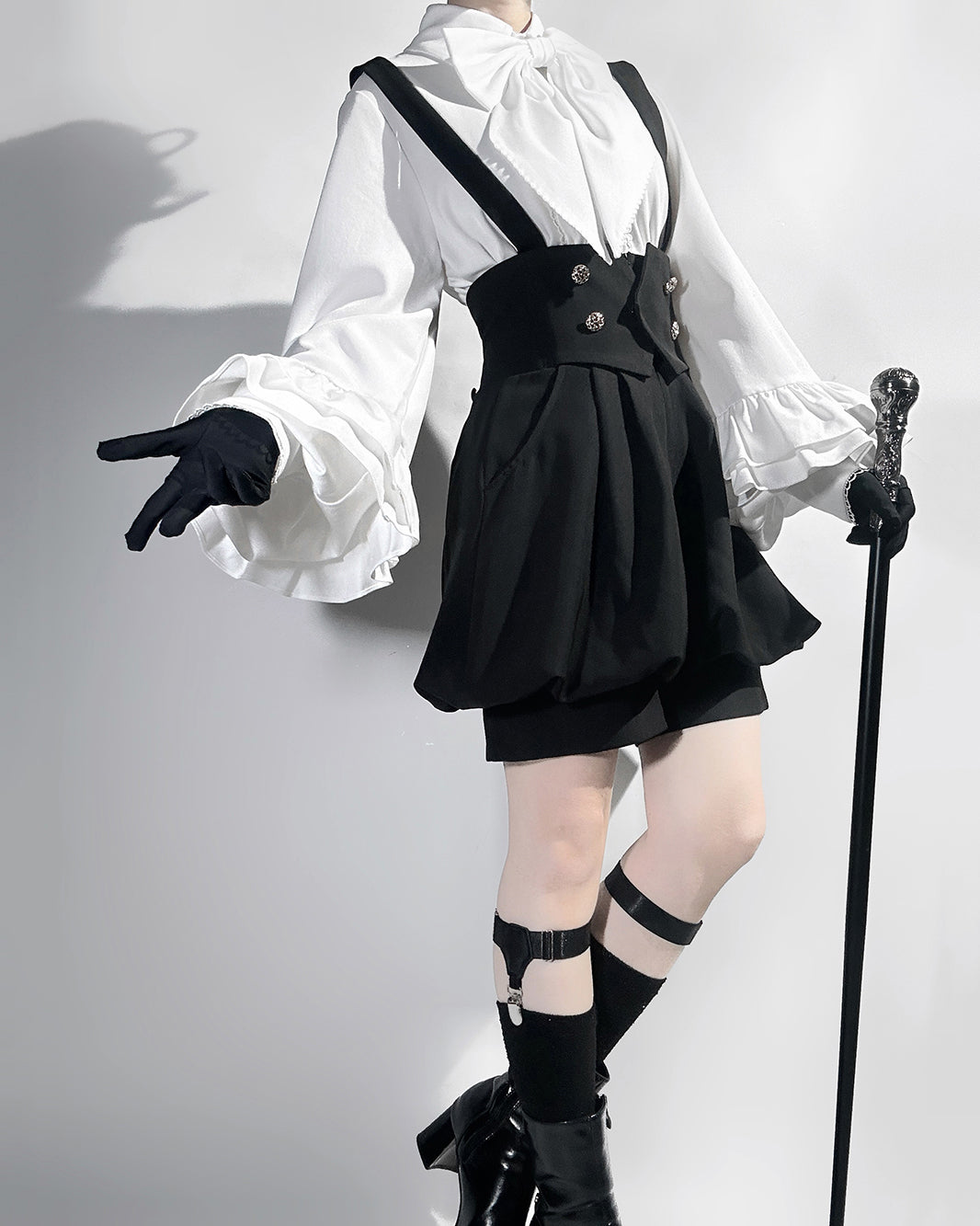 Stylish Black High-Waisted Suspender Shorts with Flared Skirt Overlay
