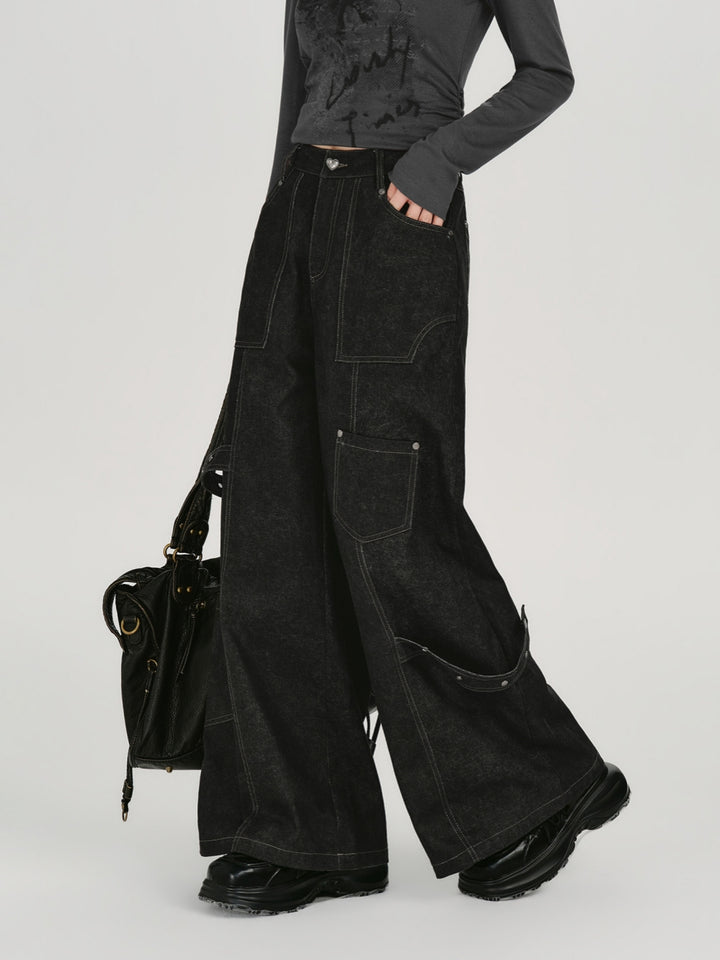 Black wide leg cargo jeans with white contrast stitching and utility pockets.