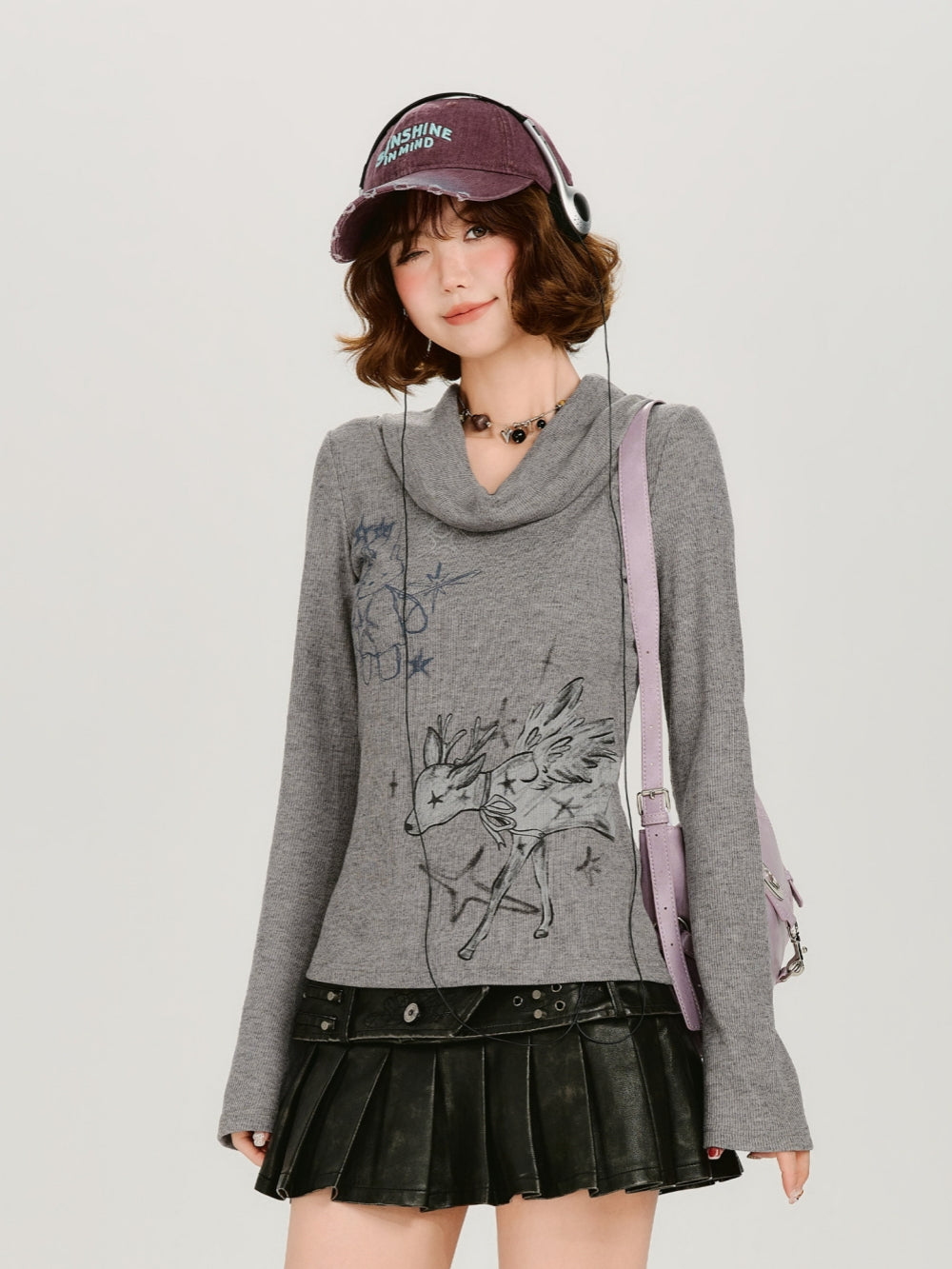 Beige oversized sweatshirt with star studs and gothic fairycore graphic print.