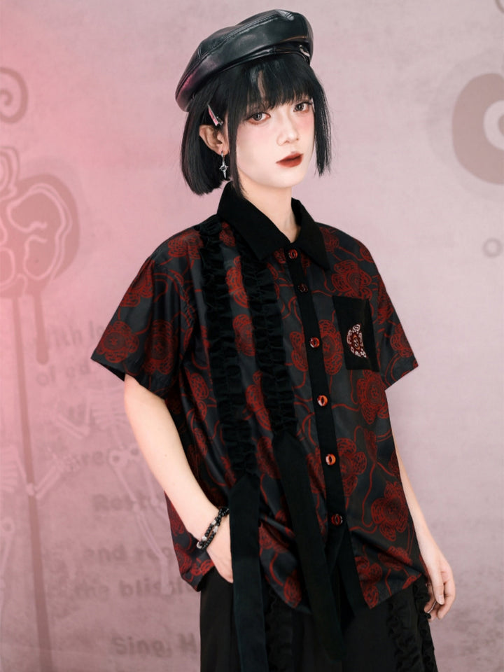Front view of a model in a dark red rose gothic shirt with a unique vertical ruffle detail and rose chest patch, styled with a leather beret and dark academia accessories.