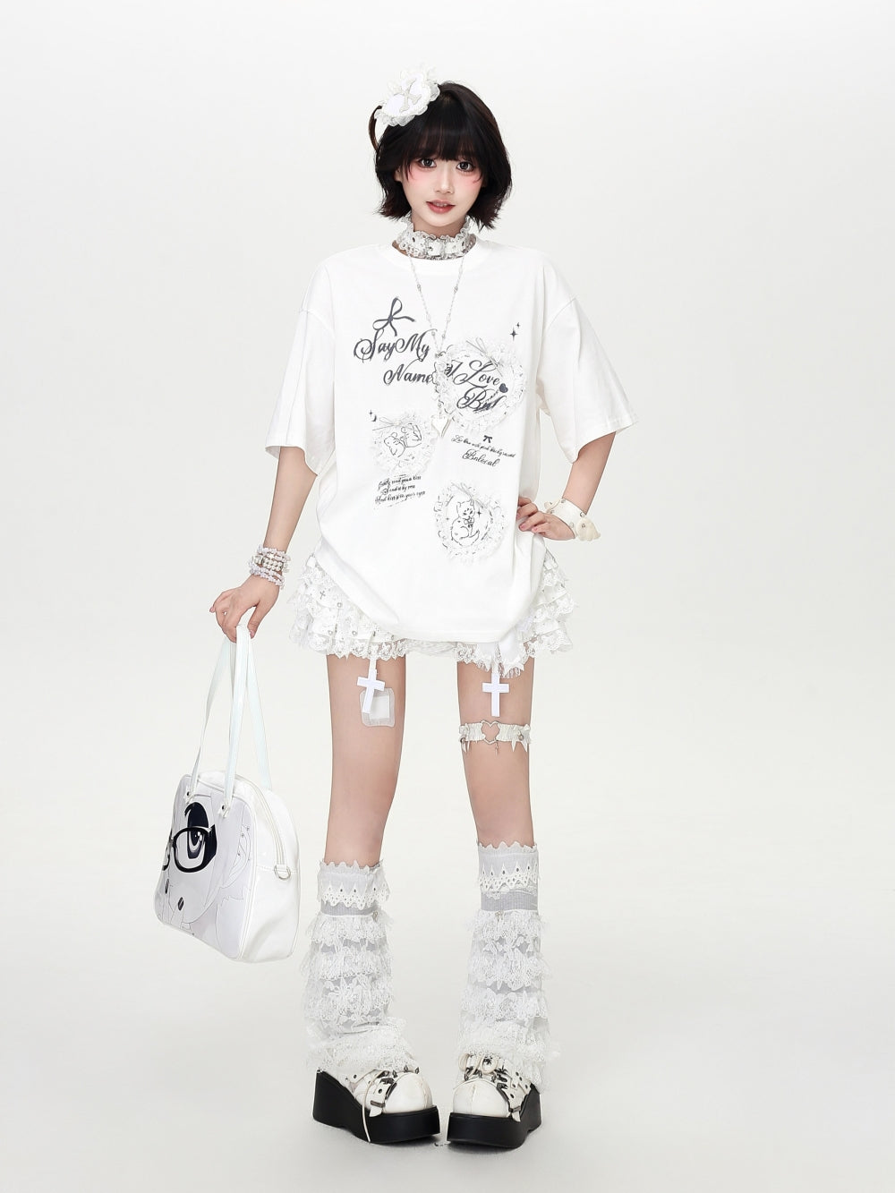 Model wearing a grey and white Cyber Y2K coquette oversized t-shirt with aesthetic lace frame and bow graphics.