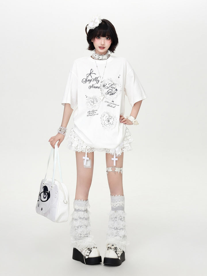 Model wearing a grey and white Cyber Y2K coquette oversized t-shirt with aesthetic lace frame and bow graphics.