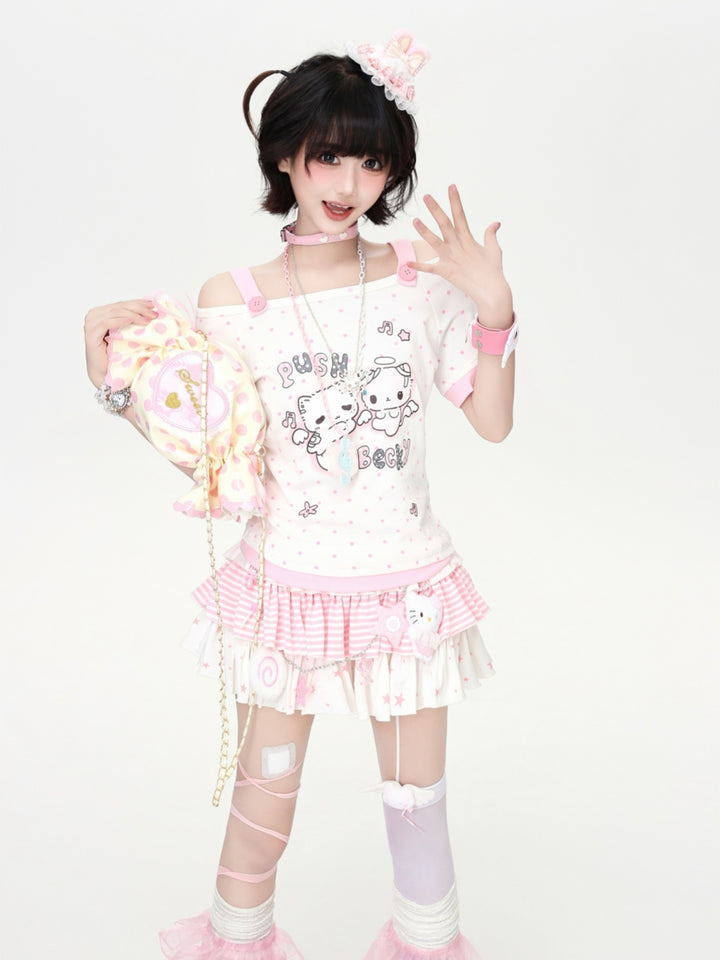 Model wearing a pastel pink and green Cyber Y2K kawaii anime graphic tee with contrast polka dots and cold-shoulder strap detail.