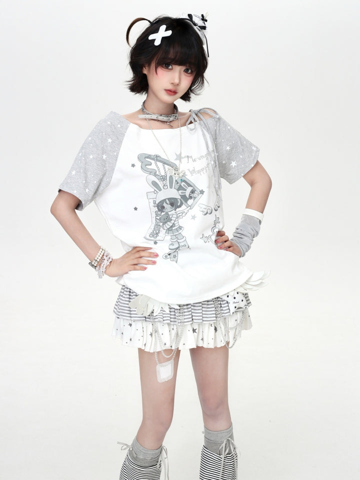 Model wearing a white and grey star-patterned Cyber Y2K cold shoulder graphic tee with a cute anime bunny character illustration.