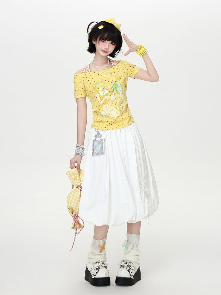 Model wearing a yellow and white polka dot Cyber Y2K kawaii graphic crop top with built-in striped halter straps and a retro anime character print.