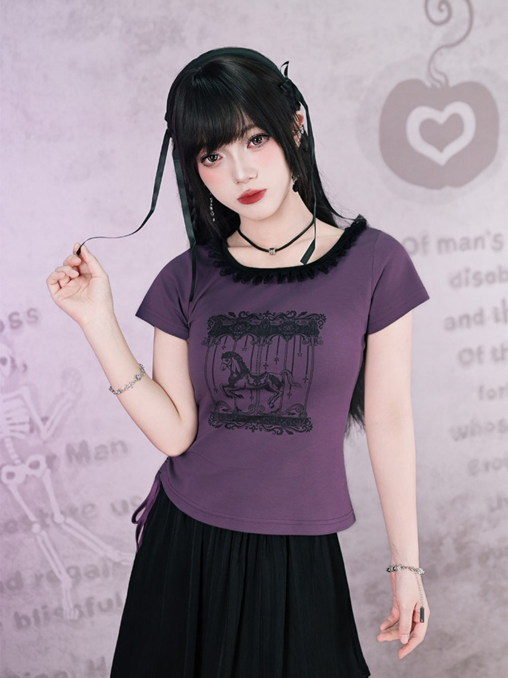 Model wearing a plum purple Cyber Y2K whimsigoth graphic tee with a black lace-trimmed neckline and dark carousel print.