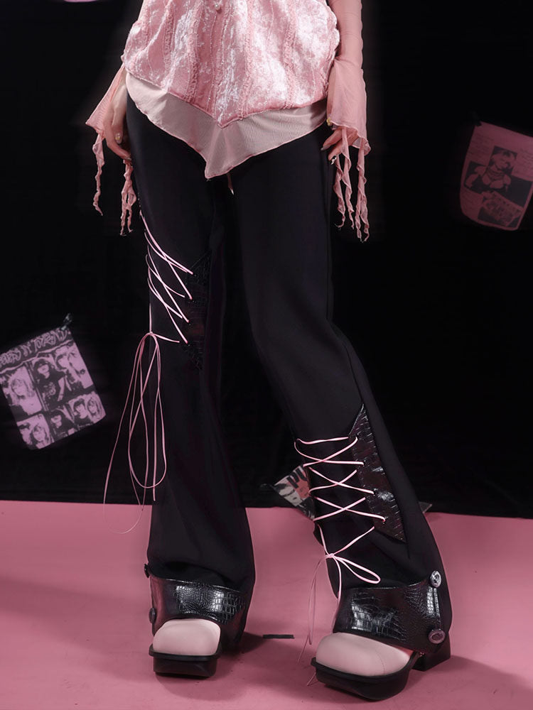 Pink crisscross ties span inset panels at different heights on the legs of these black flared pants.