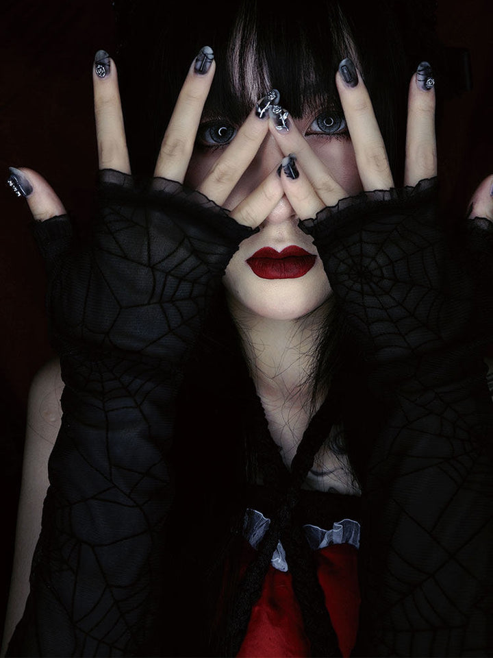 Black fingerless gloves extend along the forearms, with spiderweb patterns across the hands and arms and small ruffles edging the openings.